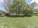 Expansive backyard with lush green grass, mature trees, and a privacy fence, perfect for outdoor activities at 4759 Silver Hill Dr, Greenwood, IN 46142