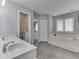 The elegant bathroom is complete with a double sink vanity, luxurious tub, and generous natural light at 4759 Silver Hill Dr, Greenwood, IN 46142