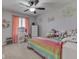 Bright bedroom featuring peach curtains and rainbow bedding filled with stuffed animals at 4759 Silver Hill Dr, Greenwood, IN 46142