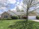Well-maintained front yard with mature landscaping, brick exterior, and attached two-car garage at 4759 Silver Hill Dr, Greenwood, IN 46142