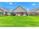 Spacious backyard featuring a grill, patio seating, and well-manicured lawn ideal for entertaining at 4809 Ozark Ln, Indianapolis, IN 46239