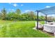 Lush green backyard with a metal pergola offering a serene outdoor space at 4809 Ozark Ln, Indianapolis, IN 46239
