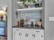 Stylish bar area with white cabinets, decorative shelves, and elegant accents at 4809 Ozark Ln, Indianapolis, IN 46239