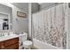 Functional bathroom with wooden vanity, mirror, toilet, and tiled shower-tub combo at 4809 Ozark Ln, Indianapolis, IN 46239