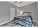 This cozy bedroom features neutral paint, hardwood floors and an open doorway at 4809 Ozark Ln, Indianapolis, IN 46239