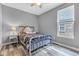 Cozy bedroom features neutral walls, ceiling fan, and natural light from a window at 4809 Ozark Ln, Indianapolis, IN 46239