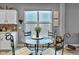 Charming dining area features a glass-top table, comfortable seating, and a view outside at 4809 Ozark Ln, Indianapolis, IN 46239