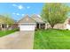 Charming single-Gathering home features a two-car garage, lush lawn, and inviting curb appeal at 4809 Ozark Ln, Indianapolis, IN 46239