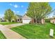 A beautiful home with a well-manicured lawn and lush green trees at 4809 Ozark Ln, Indianapolis, IN 46239