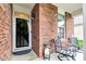 Cozy porch with chairs and decor, set in front of a brick home at 4809 Ozark Ln, Indianapolis, IN 46239