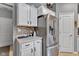 Well-organized kitchen boasts white cabinets, tiled backsplash, and stainless steel refrigerator at 4809 Ozark Ln, Indianapolis, IN 46239