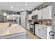 Modern kitchen with stainless appliances, white cabinets, and granite countertops at 4809 Ozark Ln, Indianapolis, IN 46239