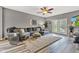 Comfortable living room with a large sectional couch, ceiling fan, and light gray walls at 4809 Ozark Ln, Indianapolis, IN 46239