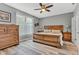 Comfortable main bedroom showcasing a wooden bed frame, a window, and side tables at 4809 Ozark Ln, Indianapolis, IN 46239