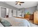 Bright main bedroom featuring neutral walls, a ceiling fan, and wooden furniture at 4809 Ozark Ln, Indianapolis, IN 46239