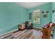 Cozy room with blue walls and wood-look vinyl flooring, perfect for a home office at 4809 Ozark Ln, Indianapolis, IN 46239