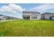 Expansive backyard featuring a covered patio and a large grassy area at 4844 Morenci Ct, New Palestine, IN 46163