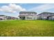 Landscaped backyard showing the patio, lawn, and nearby houses at 4844 Morenci Ct, New Palestine, IN 46163