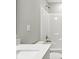 Modern bathroom with a white granite sink countertop and tile shower with brushed silver shower head at 4844 Morenci Ct, New Palestine, IN 46163