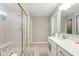 Modern bathroom with a glass shower and white granite sink countertop at 4844 Morenci Ct, New Palestine, IN 46163