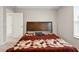 Cozy bedroom with a dark wood headboard and colorful patchwork quilt on the bed at 4844 Morenci Ct, New Palestine, IN 46163