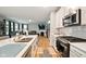 Modern kitchen with stainless steel appliances, white cabinetry, and a stylish sink area at 4844 Morenci Ct, New Palestine, IN 46163