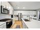 Bright kitchen featuring stainless steel appliances, white cabinets, and a functional layout at 4844 Morenci Ct, New Palestine, IN 46163