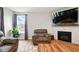 Cozy living room featuring a fireplace, mantel, and ample seating for relaxed evenings at 4844 Morenci Ct, New Palestine, IN 46163