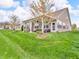 Spacious backyard with covered patio and well-manicured lawn perfect for outdoor enjoyment at 4857 Silverbell Dr, Plainfield, IN 46168