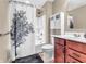 Well-lit bathroom with shower-tub combo, storage cabinet, and modern fixtures at 4857 Silverbell Dr, Plainfield, IN 46168