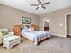 Comfortable bedroom featuring a cushioned chair, carpeted floors, and views to the en suite bathroom at 4857 Silverbell Dr, Plainfield, IN 46168