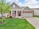 Charming single-story brick home with a manicured lawn, covered front porch and two car garage at 4857 Silverbell Dr, Plainfield, IN 46168