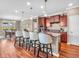 Open kitchen with dark wood cabinets, granite countertops, and a large island with seating at 4857 Silverbell Dr, Plainfield, IN 46168