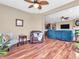 The open-concept living room is complete with a comfortable reading chair and cozy blue sectional at 4857 Silverbell Dr, Plainfield, IN 46168