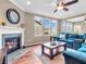 Cozy living room features a fireplace, large windows, and a comfortable blue sectional sofa at 4857 Silverbell Dr, Plainfield, IN 46168