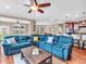Open-concept living room boasts a large blue sectional, hardwood floors, and views into the kitchen at 4857 Silverbell Dr, Plainfield, IN 46168