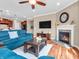 Cozy living room featuring a fireplace, comfortable seating, and an open layout to the kitchen at 4857 Silverbell Dr, Plainfield, IN 46168