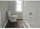 Bathroom showcasing white toilet, bathtub and neutral-tone painted walls at 509 N Emerson Ave, Indianapolis, IN 46219