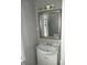 Bathroom area featuring a sink with modern faucet, a decorative mirror, and neutral tones at 509 N Emerson Ave, Indianapolis, IN 46219