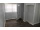 Bedroom with luxury vinyl floors, freshly painted walls, and bright window at 509 N Emerson Ave, Indianapolis, IN 46219