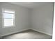 Bright bedroom features neutral walls, plush carpeting, and a window with blinds at 509 N Emerson Ave, Indianapolis, IN 46219
