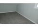 Cozy bedroom featuring gray carpeted flooring, painted walls, and a window at 509 N Emerson Ave, Indianapolis, IN 46219