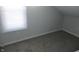 Cozy bedroom offers plush carpet, neutral color palette, and a bright window at 509 N Emerson Ave, Indianapolis, IN 46219