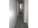Hallway view leading to a bathroom featuring neutral color palette and carpeted floor at 509 N Emerson Ave, Indianapolis, IN 46219