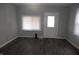 Light-filled living room boasts updated dark floors, neutral paint, and a view of the entry door at 509 N Emerson Ave, Indianapolis, IN 46219