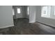 Light-filled living room boasts updated dark floors, neutral paint, and a view of the entry at 509 N Emerson Ave, Indianapolis, IN 46219