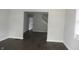 Inviting living room showcasing dark vinyl flooring, painted walls, and staircase at 509 N Emerson Ave, Indianapolis, IN 46219