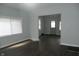 Open-concept living room features dark vinyl floors and light-colored walls at 509 N Emerson Ave, Indianapolis, IN 46219