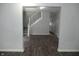 Open-concept living room features staircase with white railings, dark flooring, and neutral colors at 509 N Emerson Ave, Indianapolis, IN 46219