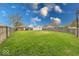 Large backyard with a wooden fence and lush lawn, perfect for outdoor activities and privacy at 517 S 4Th Ave, Beech Grove, IN 46107